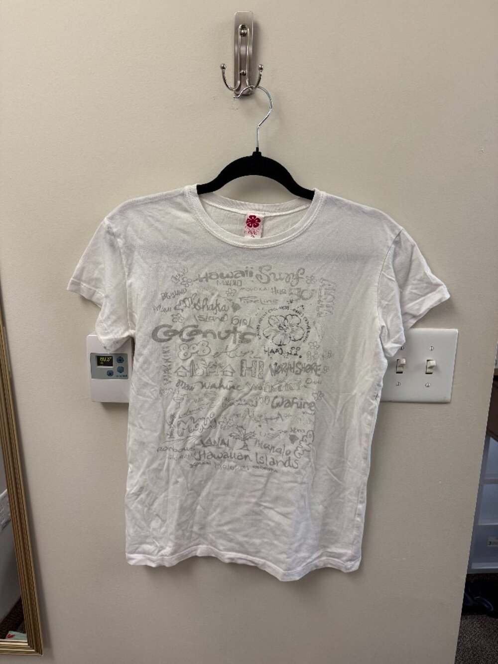 white tshirt thin build with silver lettering and flower images